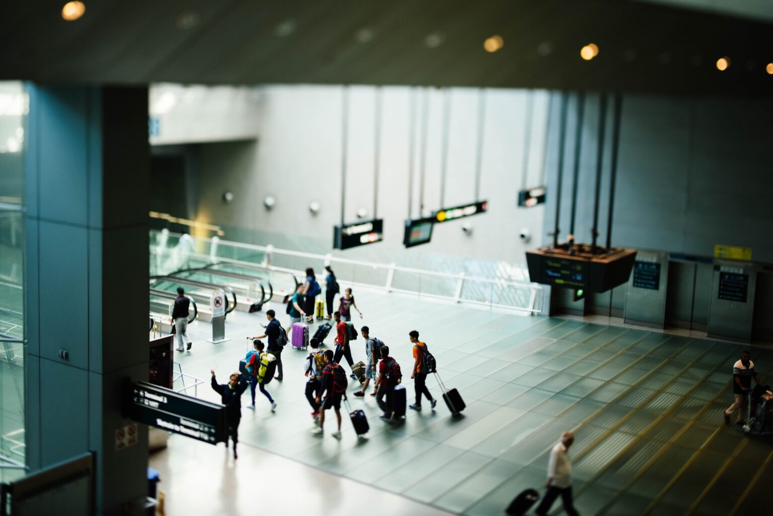 Travelers using the escalator of an airport