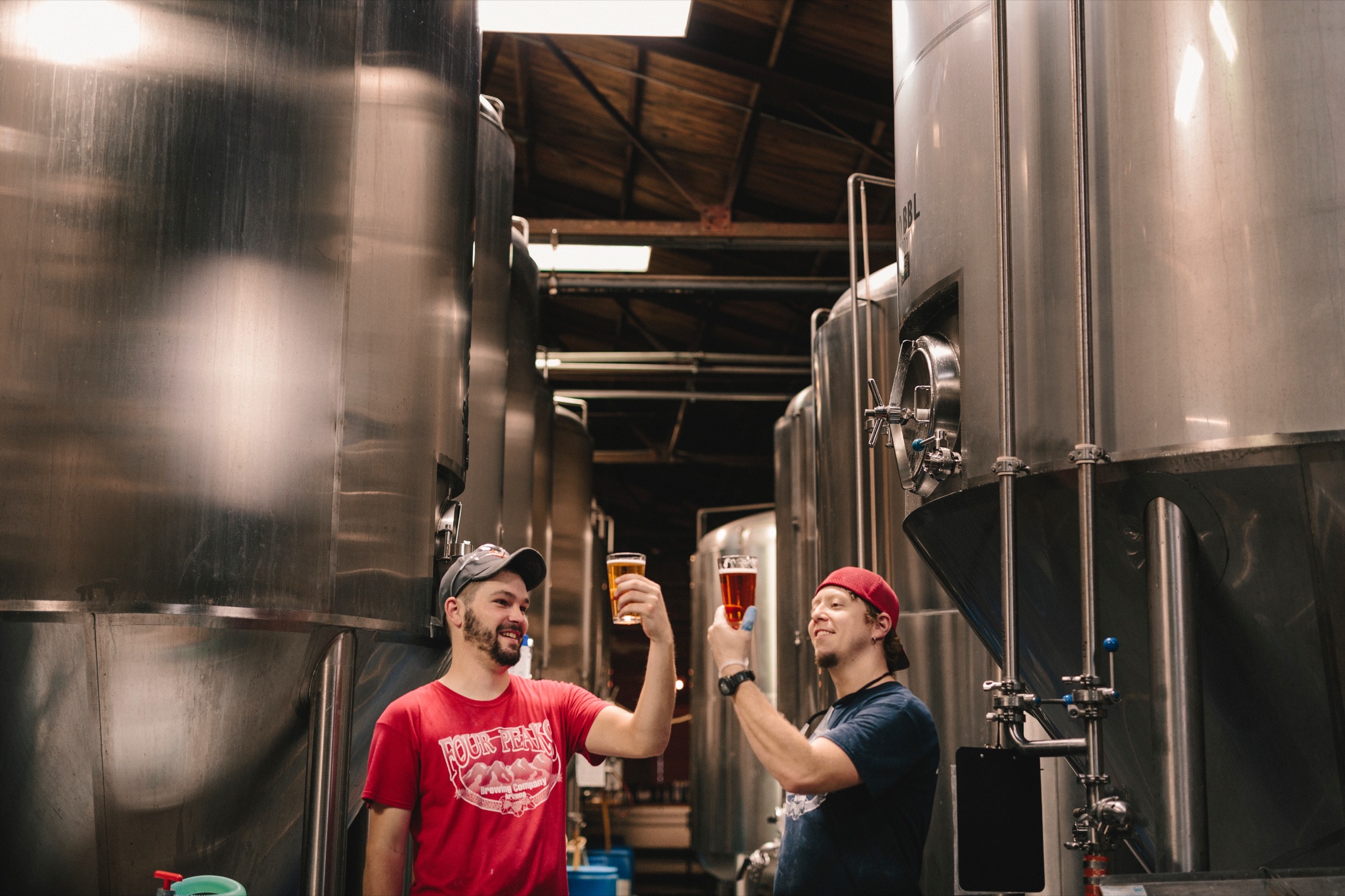 Two brewery employees inspect the beer