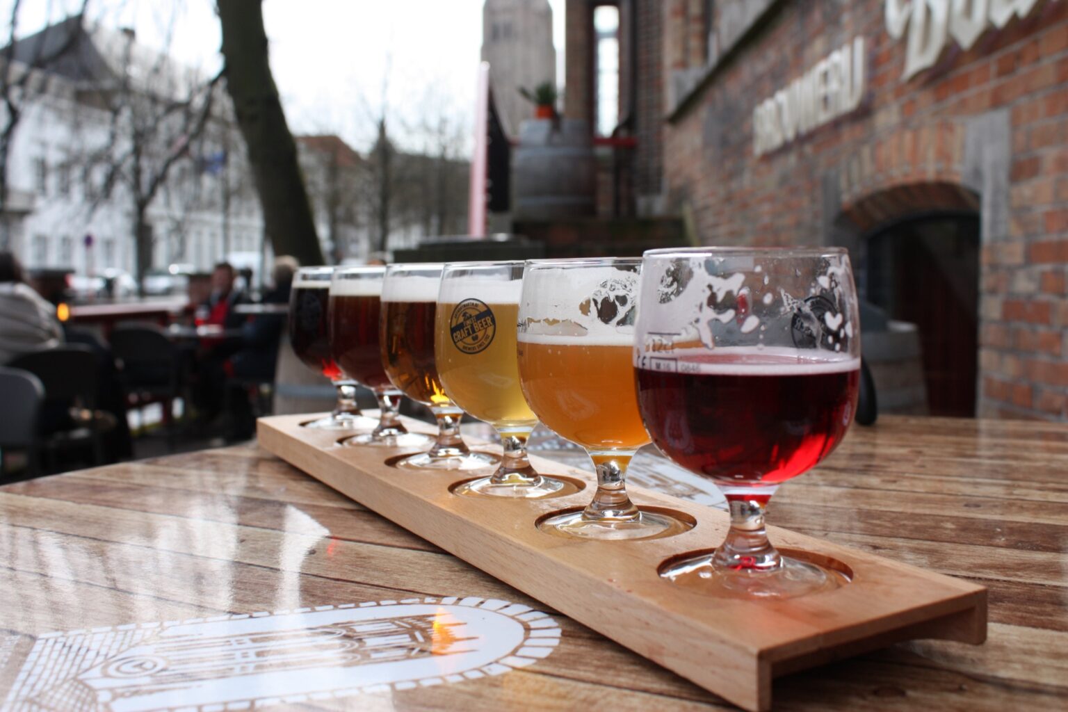 A flight of craft beers served outdoors