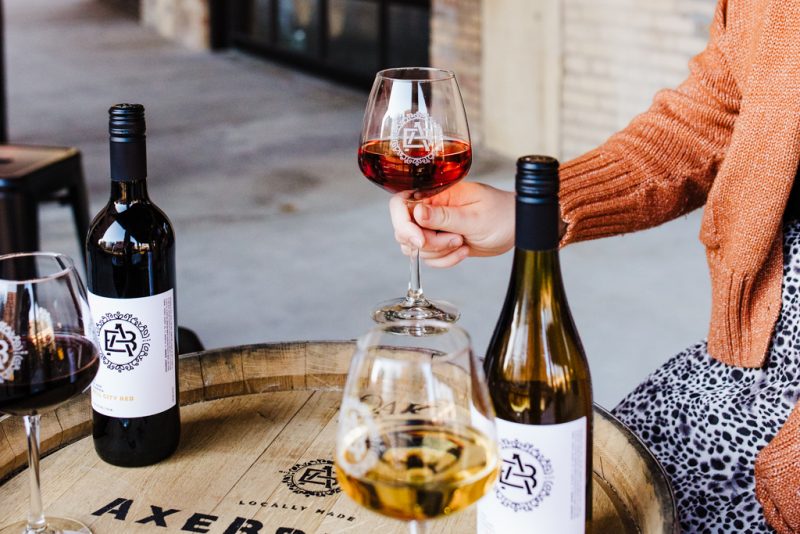 A glass of wine being held while tasting different wines