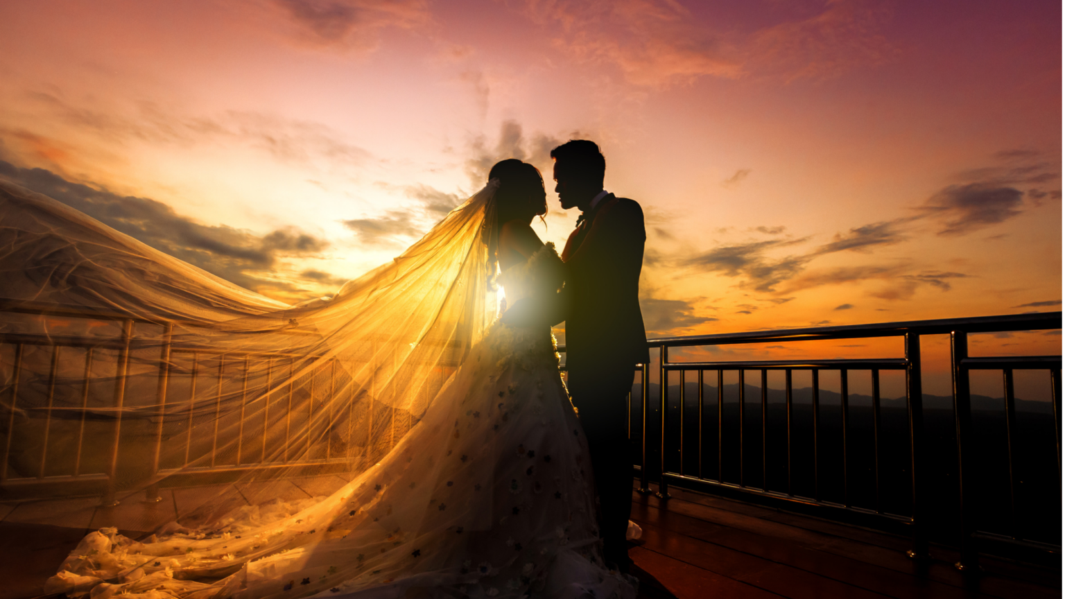 Wedding couple sharing a private moment outdoors at sunset