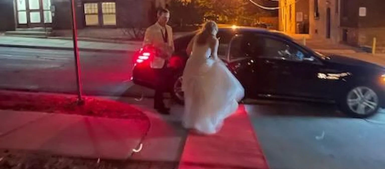 Happy bride and groom end their night with a red-carpet getaway from the reception.