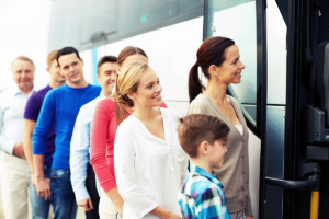 A group of people ready to board a coach bus from Executive Transportation.