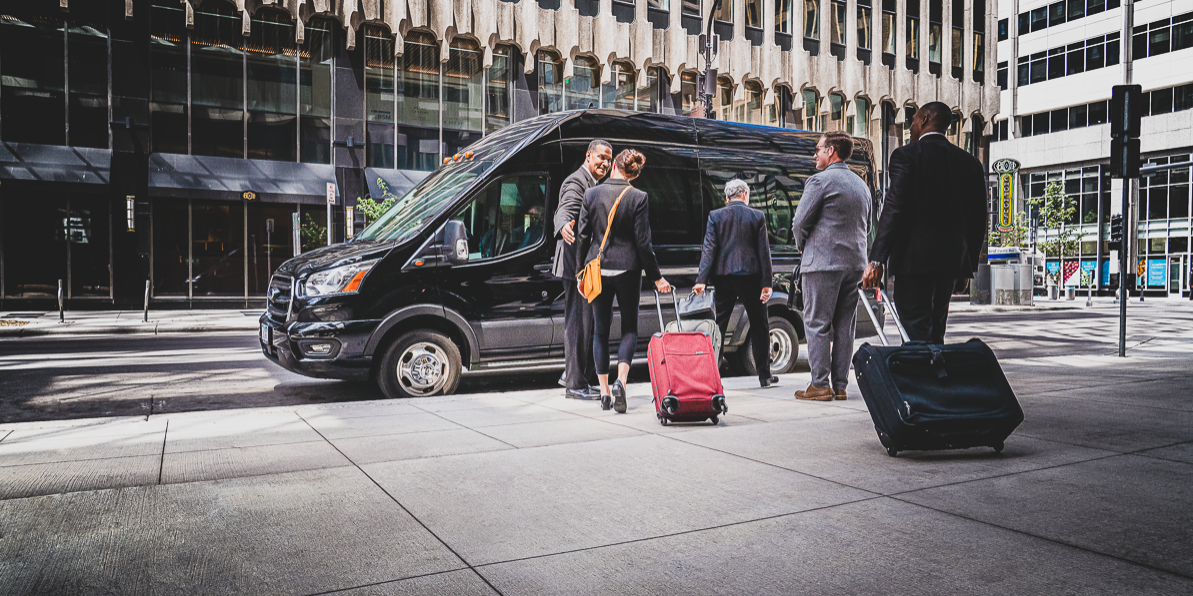 Business travelers leaving downtown for the airport together in a chauffeured executive van