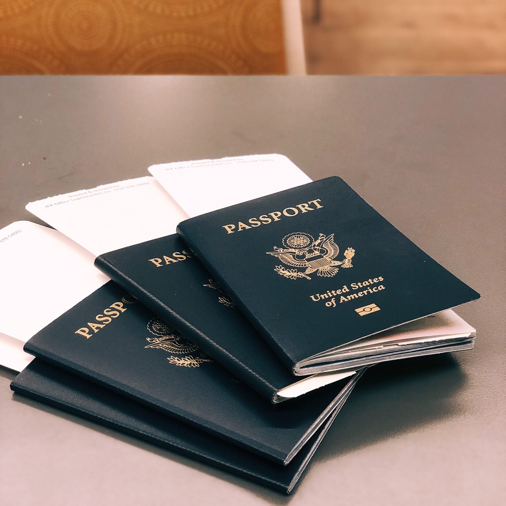 Four U.S. passports stacked on each other