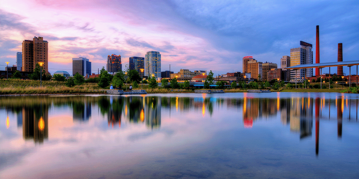 Birmingham Alabama skyline reflected on calm waters.