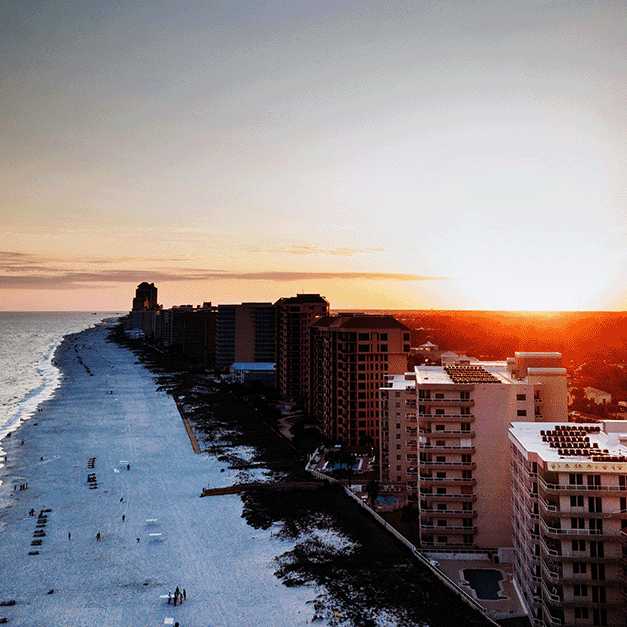White sand beaches of the Alabama Gulf Coast at sunset.