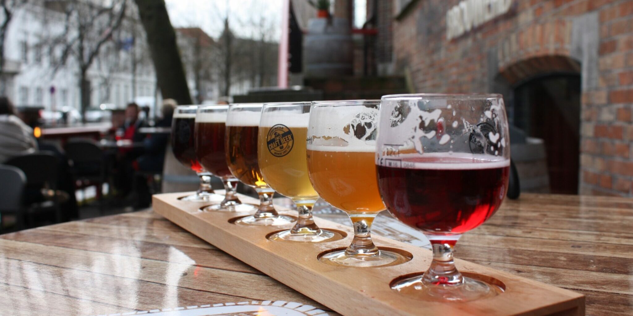 A flight of craft beers served outdoors