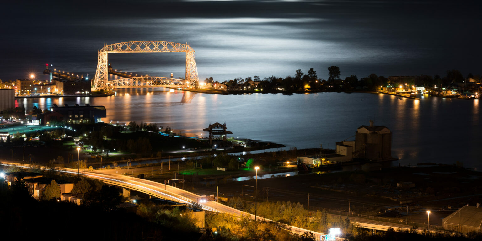 Duluth Minnesota view from the hill looking over the lake with the lift bridge lit at night