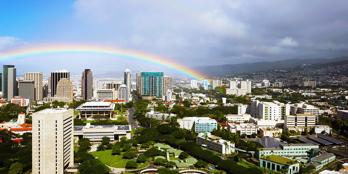 Looking over Hololulu Hawaii with a rainbow in the sky.