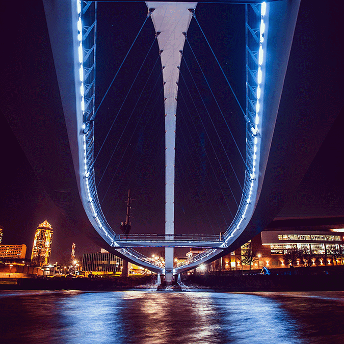 Looking across the water under a modern bridge at Des Moines, Iowa.