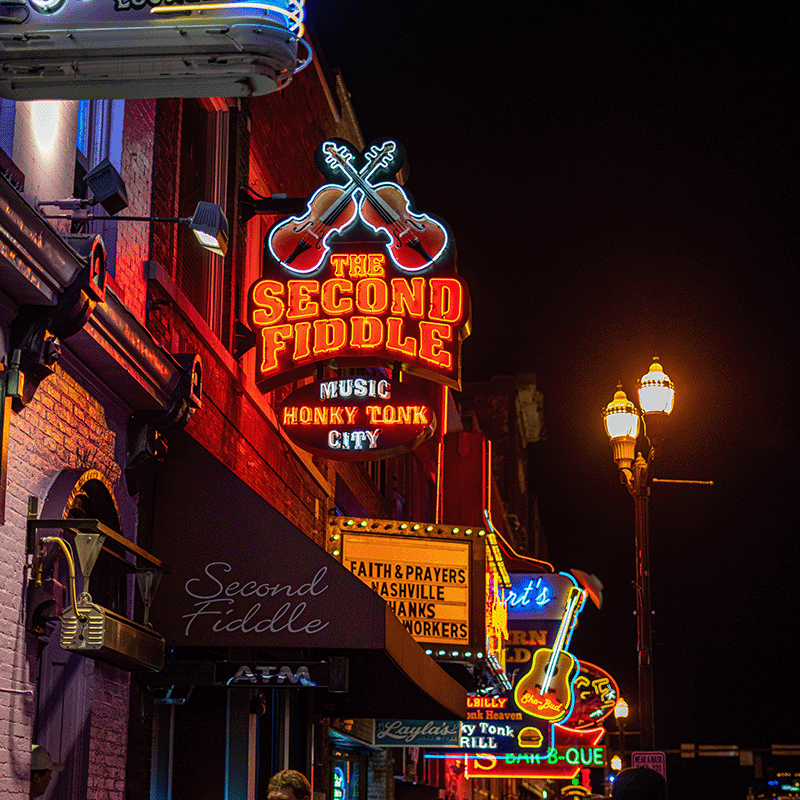 Nashville at night, along the neon-sign lit sidwalks.