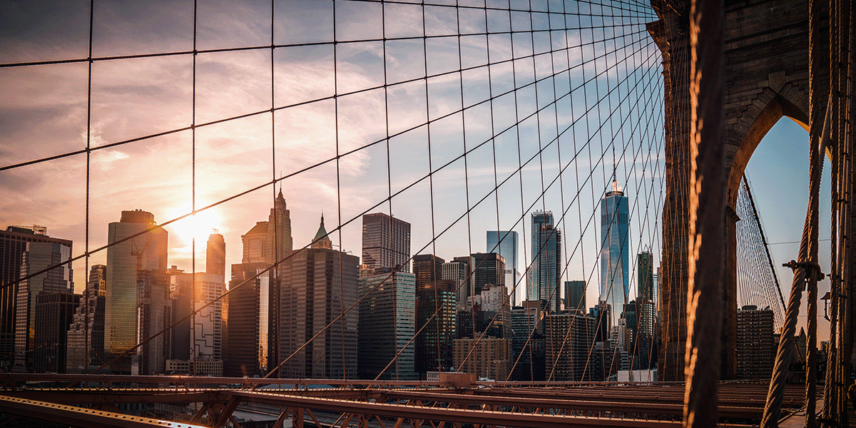 View of downtown New York City through the guide wires of the bridge.