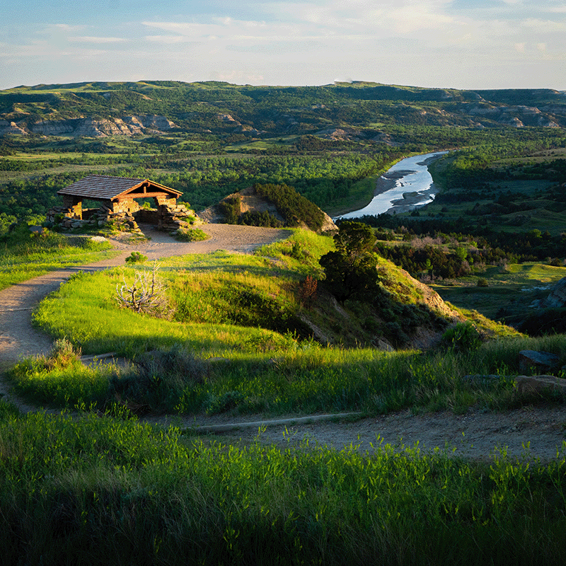 A shelter and the river running through Theodore Roosevelt National Park in North Dakota at sunset.