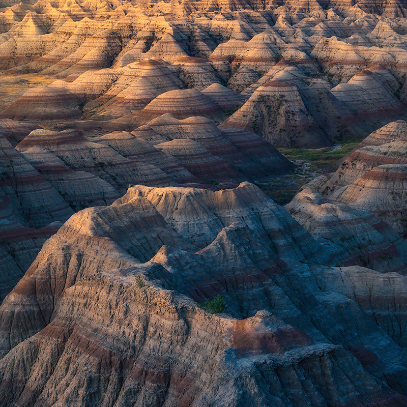 An aerial view of the rocky formations in the badlands of South Dakota at sunset.
