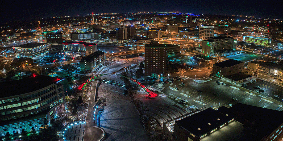 A view of Sioux Falls, South Dakota at night with the winter holiday lights illuminating the streets.