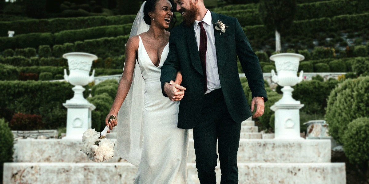 Happy couple walks back to their waiting chauffeur to continue the celebrations on their wedding day.