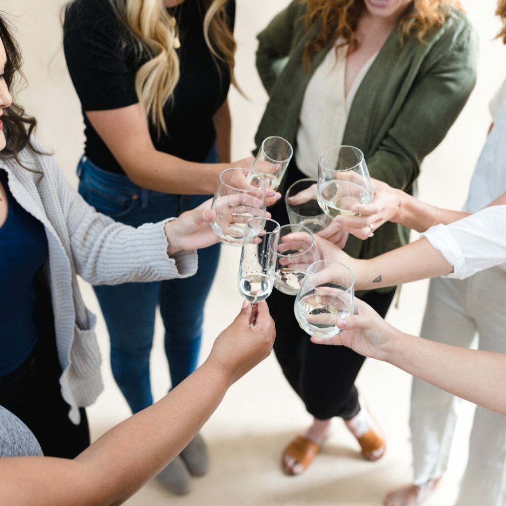 Women toasting while standing in a circle